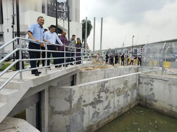 黄思汉（左）喜见防洪工程接近完工，解决当地突发性水灾困扰。